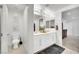 Modern bathroom with dual sink vanity, toilet, and tiled floors at 12541 Lylan Ridge St, Las Vegas, NV 89138