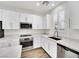 Modern kitchen with stainless steel appliances and quartz countertops, and white cabinetry at 12541 Lylan Ridge St, Las Vegas, NV 89138