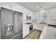 Modern kitchen with stainless steel appliances, white cabinetry, and quartz countertops at 12541 Lylan Ridge St, Las Vegas, NV 89138