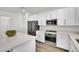 Beautiful kitchen with stainless steel appliances, white cabinetry and a large quartz island at 12541 Lylan Ridge St, Las Vegas, NV 89138