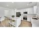 Modern kitchen with white cabinetry, stainless steel appliances, and quartz countertops at 12541 Lylan Ridge St, Las Vegas, NV 89138