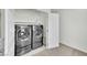 A laundry room with a large modern washer and dryer and shelving at 12541 Lylan Ridge St, Las Vegas, NV 89138