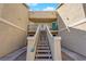 Exterior view of a home featuring an upstairs unit with balconies and convenient stairway access at 1541 Linnbaker Ln # 202, Las Vegas, NV 89110