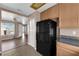 View of kitchen leading to an open living space with wood look vinyl floors at 1541 Linnbaker Ln # 202, Las Vegas, NV 89110