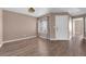 Living room featuring wood-look floors, neutral walls, and a front door at 1541 Linnbaker Ln # 202, Las Vegas, NV 89110