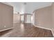 Bright living room featuring wood-look floors, neutral walls, and a front door at 1541 Linnbaker Ln # 202, Las Vegas, NV 89110