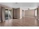 Living room featuring wood-look floors, neutral walls, and a sliding door at 1541 Linnbaker Ln # 202, Las Vegas, NV 89110