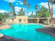 Inviting community pool with sparkling water surrounded by lush landscaping and tall palm trees at 1541 Linnbaker Ln # 202, Las Vegas, NV 89110