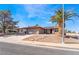 Lovely single-story home boasting a tiled roof and xeriscaped front yard with mature landscaping at 181 Lido Cir, Henderson, NV 89015