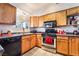 Well-lit kitchen with oak cabinets, stainless steel appliances, and a practical layout for easy cooking at 181 Lido Cir, Henderson, NV 89015