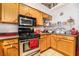 Functional kitchen featuring wooden cabinets, a gas range, and plenty of countertop space for meal prep and storage at 181 Lido Cir, Henderson, NV 89015