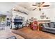 Comfortable living room featuring a ceiling fan, tile accents, and ample natural light at 181 Lido Cir, Henderson, NV 89015