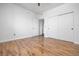 Bedroom showcasing wood-look floors, a closet with sliding doors, and neutral decor at 1830 N Buffalo Dr # 1019, Las Vegas, NV 89128