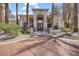 Elegant clubhouse entrance with arched doorway, manicured landscaping, and a welcoming pathway at 1830 N Buffalo Dr # 1019, Las Vegas, NV 89128