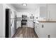 Kitchen featuring stainless steel appliances, white cabinets, and wood-look floors at 1830 N Buffalo Dr # 1019, Las Vegas, NV 89128