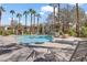 Refreshing community pool surrounded by lounge chairs, palm trees, and well-maintained landscaping at 1830 N Buffalo Dr # 1019, Las Vegas, NV 89128