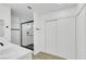 Modern bathroom featuring a glass-enclosed shower, sleek fixtures, and convenient sliding door closet at 1905 Joella St, Las Vegas, NV 89108