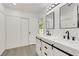 Bright bathroom features double sinks, modern fixtures, stylish mirrors, and a large sliding door closet at 1905 Joella St, Las Vegas, NV 89108