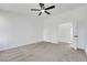 Cozy carpeted bedroom with white walls, ceiling fan, and access to additional rooms through a set of double doors at 1905 Joella St, Las Vegas, NV 89108