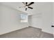 Bright bedroom features modern ceiling fan, neutral carpet, and a sunny window at 1905 Joella St, Las Vegas, NV 89108