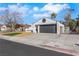 Single-story home with an attached two-car garage, well kept lawn, and white stucco exterior at 1905 Joella St, Las Vegas, NV 89108