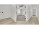 Hallway with light floors, white walls and doors, and a view to a carpeted bedroom at 1905 Joella St, Las Vegas, NV 89108