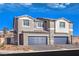 Modern two-story home featuring a two-car garage and neutral color scheme against a clear blue sky at 192 Biscotti Ave # Lot 120, North Las Vegas, NV 89084