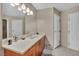 Bathroom with wooden vanity, white countertop, large mirror, modern lights and neutral walls at 200 W Sahara Ave # 1711, Las Vegas, NV 89102