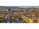 Expansive city view with a mix of residential and commercial buildings against a mountain backdrop at sunset at 200 W Sahara Ave # 1711, Las Vegas, NV 89102