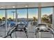 Large windows provide views from the fitness center's treadmills toward the outdoor pool and city at 200 W Sahara Ave # 1711, Las Vegas, NV 89102