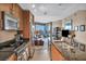 Modern kitchen featuring wood cabinets, stainless steel appliances, and a view to the living room at 200 W Sahara Ave # 1711, Las Vegas, NV 89102