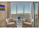 Bright living room with floor to ceiling windows providing stunning city views and modern furniture at 200 W Sahara Ave # 1711, Las Vegas, NV 89102