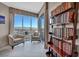 Bright living room with floor to ceiling windows providing stunning city views and filled bookcase at 200 W Sahara Ave # 1711, Las Vegas, NV 89102