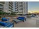 Inviting outdoor area with comfortable blue seating, a barbecue, and pool access at 200 W Sahara Ave # 1711, Las Vegas, NV 89102