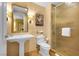 Elegant bathroom with a pedestal sink, gold-toned walls, and a glass-enclosed shower, creating a luxurious feel at 2000 N Fashion Show Dr # 5326, Las Vegas, NV 89109