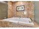 Relaxing soaking tub with marble surround and elegant fixtures at 2000 N Fashion Show Dr # 5326, Las Vegas, NV 89109