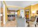 Well-lit kitchen and dining space with breakfast bar, sleek chairs, and bright, cheerful yellow walls at 2000 N Fashion Show Dr # 5326, Las Vegas, NV 89109