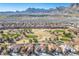 An aerial view shows houses near a golf course against a backdrop of mountains at 2265 Lauren Dr, Las Vegas, NV 89134