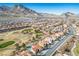 Extensive aerial view of community homes near a golf course, offering stunning mountain views at 2265 Lauren Dr, Las Vegas, NV 89134