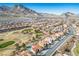 Scenic aerial view of a community nestled next to a golf course, with the mountains in the background at 2265 Lauren Dr, Las Vegas, NV 89134