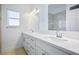 Bright bathroom features a double sink vanity, white cabinets, quartz countertop, and large mirror at 2265 Lauren Dr, Las Vegas, NV 89134