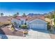 Aerial view of a beautiful home featuring a tile roof, mature landscaping, and mountain views at 2265 Lauren Dr, Las Vegas, NV 89134