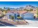 Front exterior of house with xeriscaping and mountain views in the background at 2265 Lauren Dr, Las Vegas, NV 89134