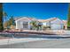 Well-maintained home with a lush desert landscape, mature palm trees, and tile roof at 2265 Lauren Dr, Las Vegas, NV 89134