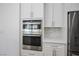 Modern kitchen with stainless steel microwave, oven, and white cabinetry at 2265 Lauren Dr, Las Vegas, NV 89134