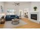 Bright living room with modern fireplace, hardwood floors, and comfortable blue sofa at 2265 Lauren Dr, Las Vegas, NV 89134