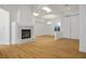 Spacious living area featuring hardwood floors, a fireplace, and stylish lighting at 2265 Lauren Dr, Las Vegas, NV 89134