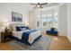 Beautiful main bedroom with tray ceiling, ceiling fan, wood floors, blue accents, and natural light at 2265 Lauren Dr, Las Vegas, NV 89134