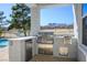 Built-in outdoor kitchen with a grill, mini-fridge, and mountain views at 2265 Lauren Dr, Las Vegas, NV 89134