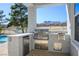 A built-in outdoor kitchen featuring stainless steel appliances and views of the community park and mountains at 2265 Lauren Dr, Las Vegas, NV 89134